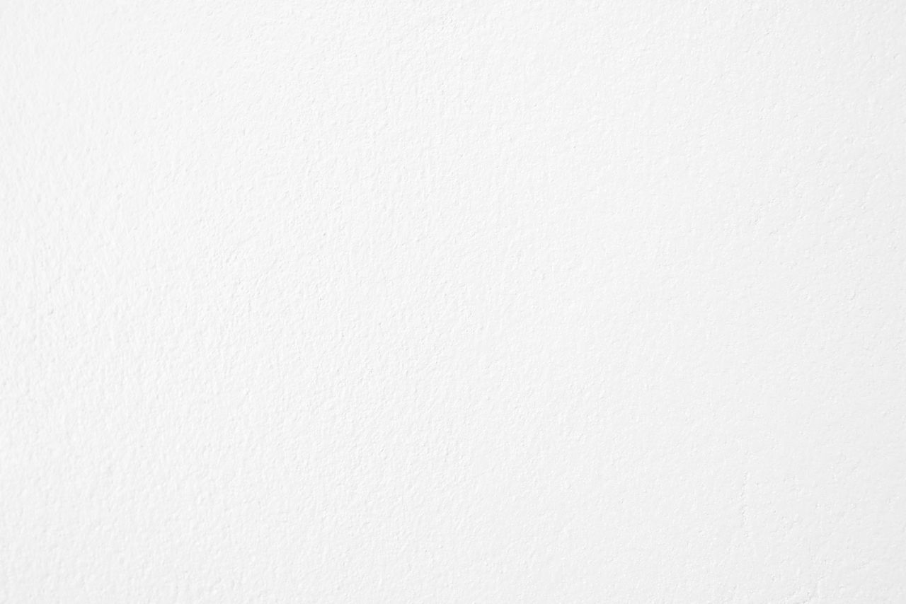 HIGH ANGLE VIEW OF WHITE WALL AGAINST BLUE BACKGROUND