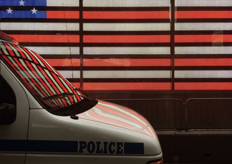 Police vehicle on street against digital american flag