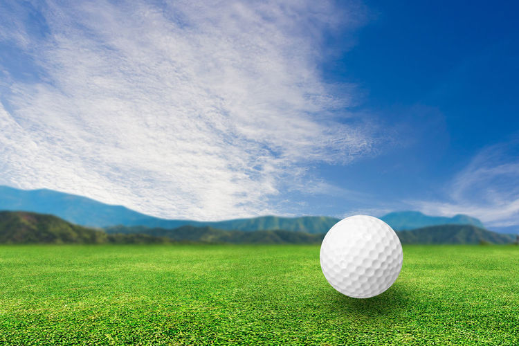 High angle view of golf ball on field against sky