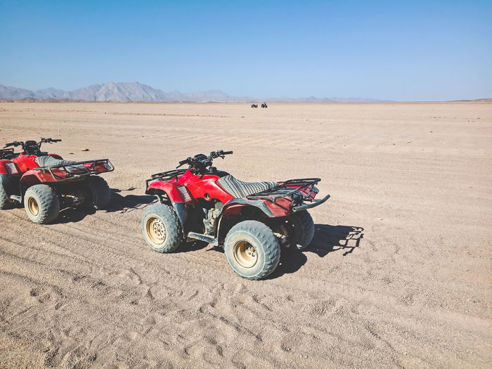 Tractor on desert against sky