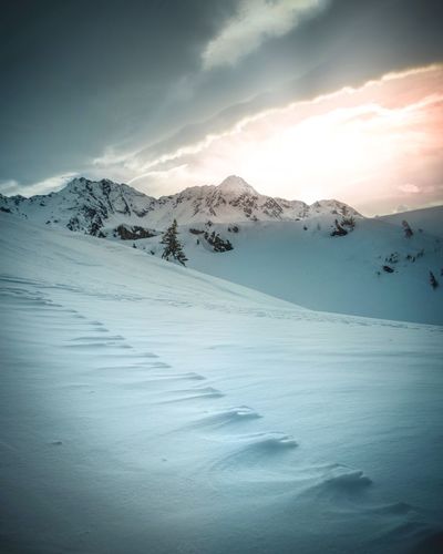 Scenic view of snow covered mountains against sky