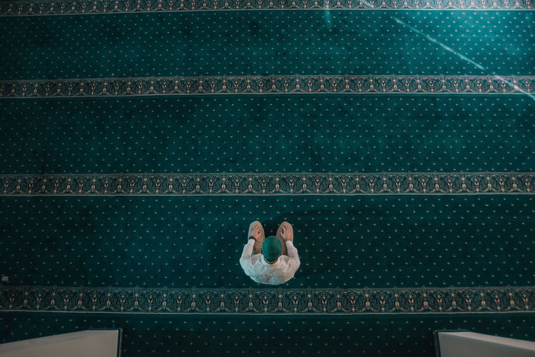 High angle view of man relaxing on floor