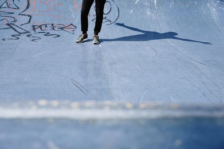 Low section of man standing at skateboard park