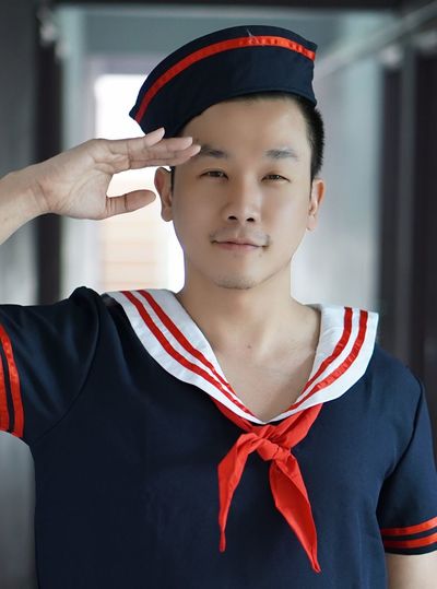 Portrait of mid adult man saluting in uniform