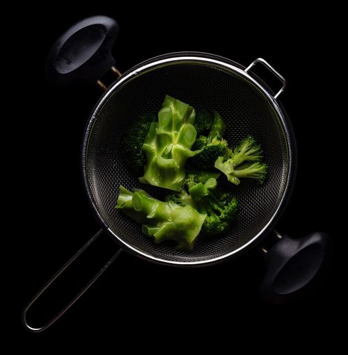 Directly above shot of salad in plate against black background