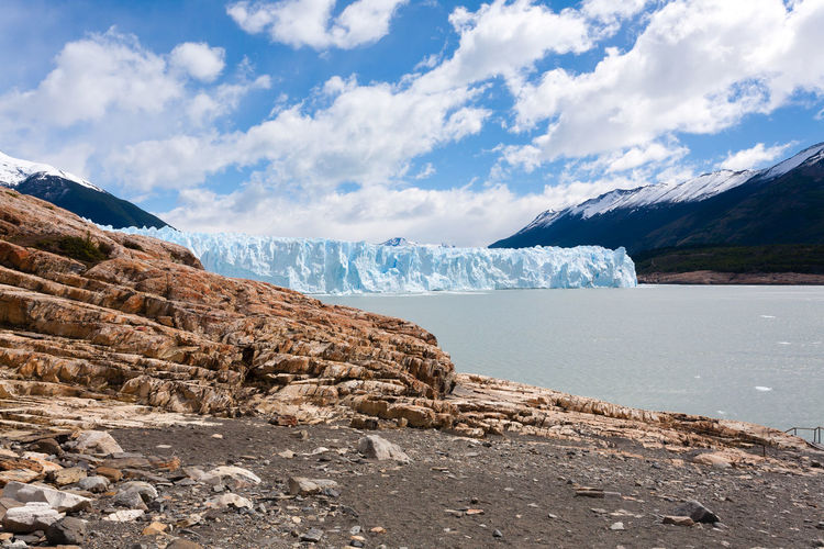 Scenic view of icebergs on lake against sky