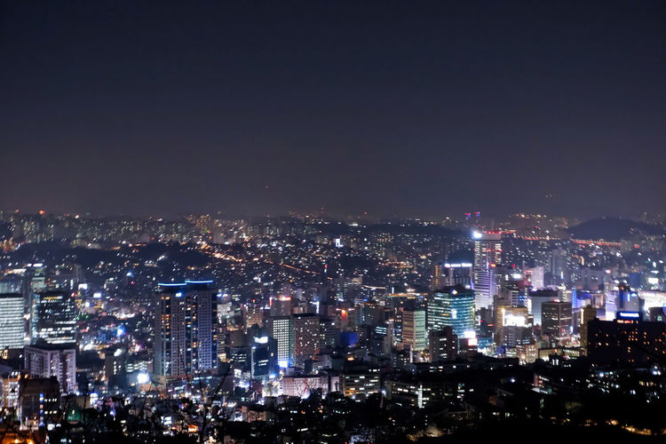 Illuminated cityscape against sky at night. taken from the namsan tower in south korea, on winter. 