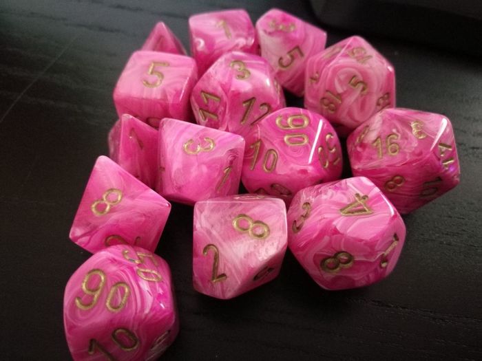 High angle view of numbers on pink dice