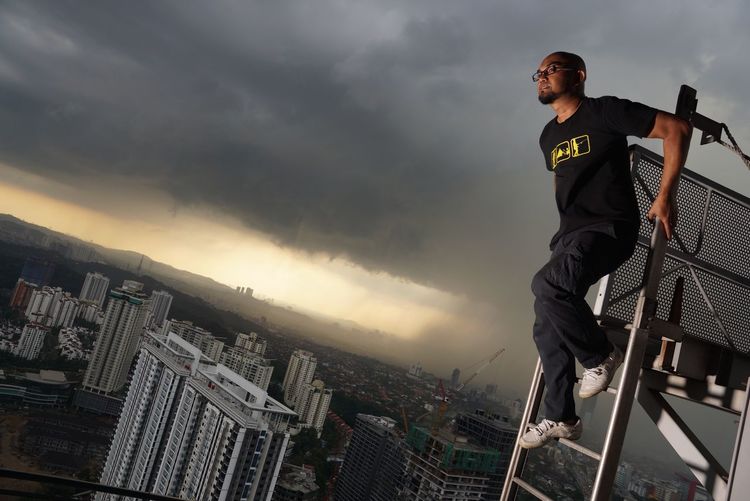 Full length of man standing against sky in city
