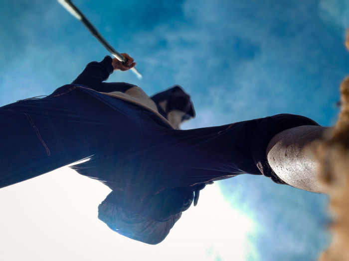 Directly below shot of man walking against sky