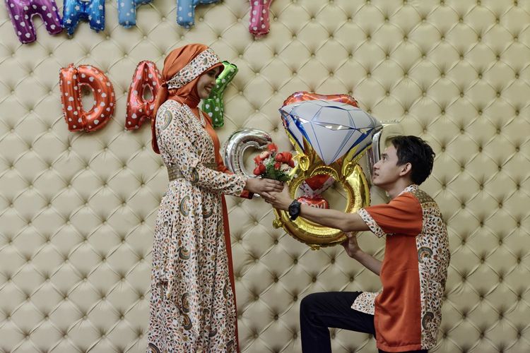 Man proposing woman during celebration