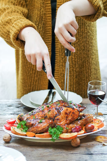 Midsection of woman preparing food on table