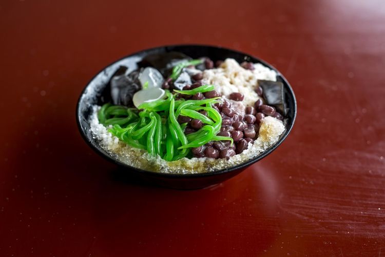 Close-up of cendol served in plate on red table