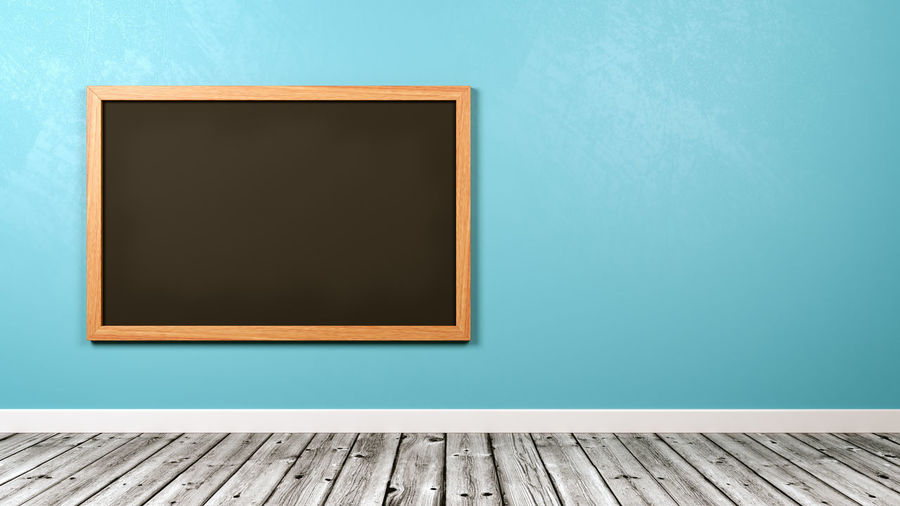 Wooden table against blue wall