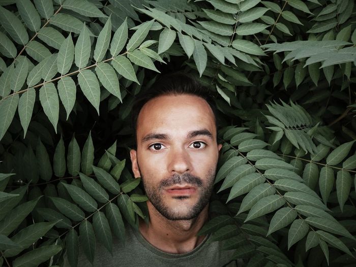Portrait of man by plants