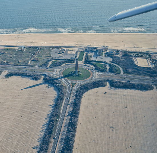 Cropped aircraft wing over water tank at jones beach state park
