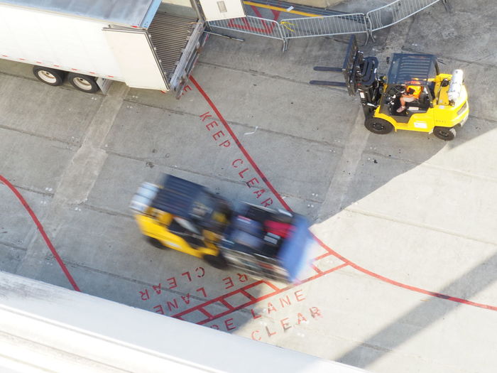 Blurred motion of forklifts in dock