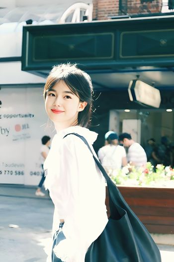Walking in front of a cafe while taking pictures