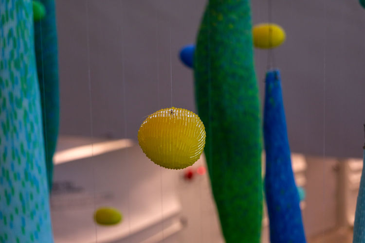 Close-up of decoration hanging on table against wall at home