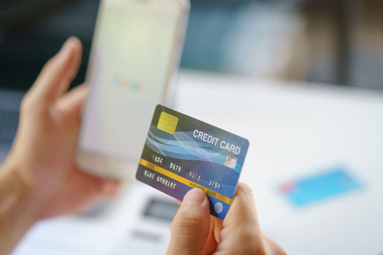 Close-up of hand holding credit card