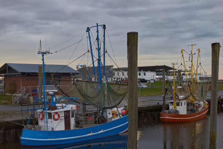 Fishtrawlers in a fish port at low tide