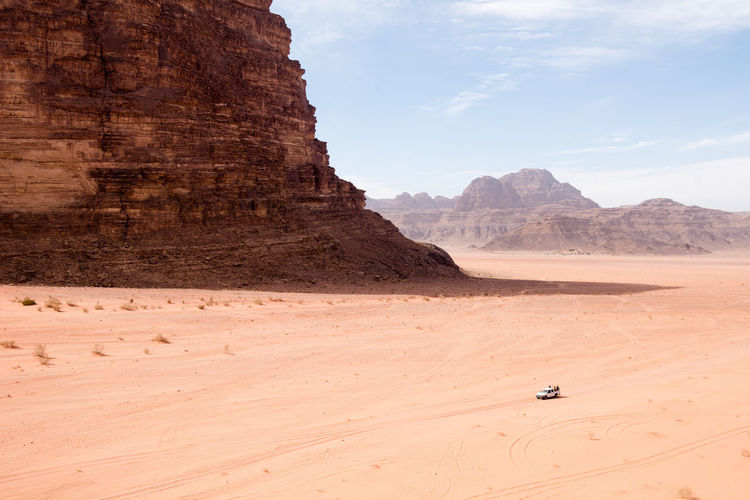 Tourists explore the vastness of the wadi rum desert in jordan.