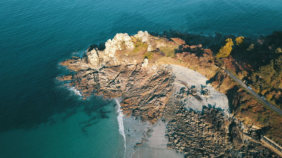 High angle view of rocks on sea shore