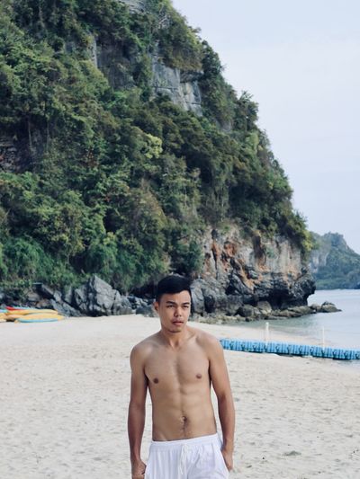 Young man standing on beach