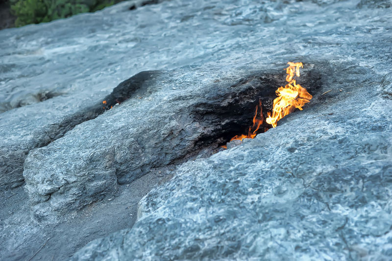 High angle view of bonfire on rock