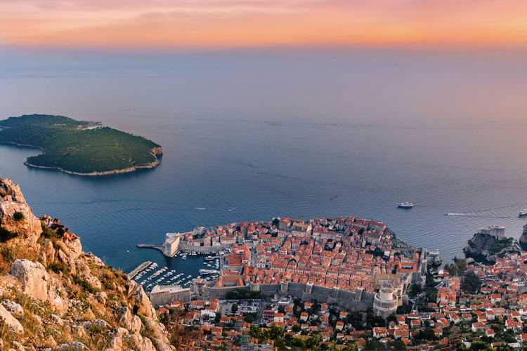 Group of teens over look dubrovnik city at sunset