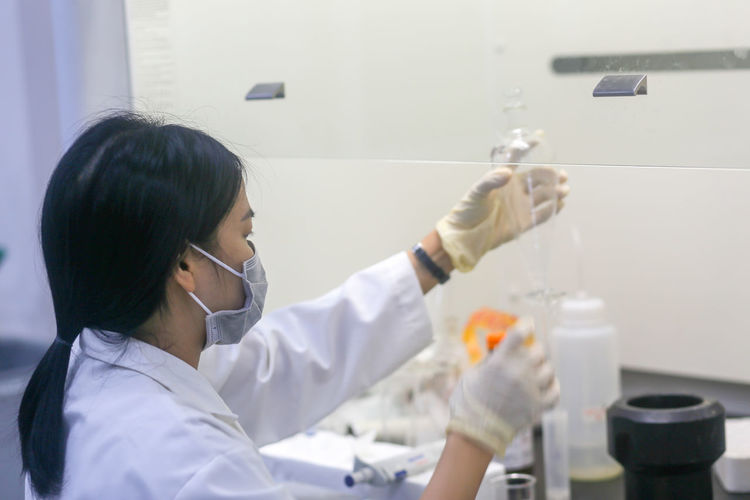 Vietnamese woman scientist making an experiment in the laboratory