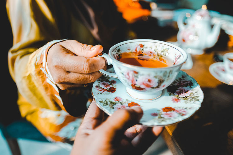 Midsection of woman holding coffee cup
