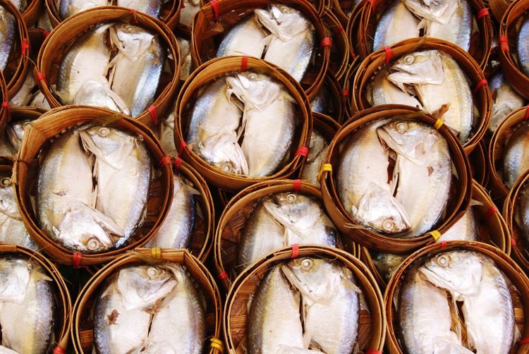 Full frame shot of mackerels in bamboo baskets at market