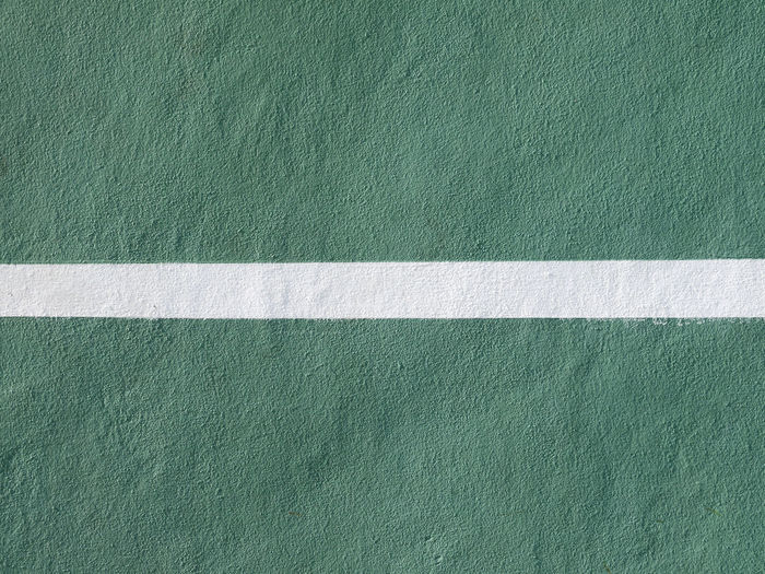 Full frame shot of green wall with white line