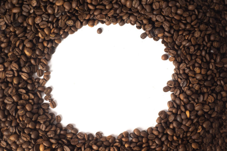 Directly above shot of coffee beans against white background