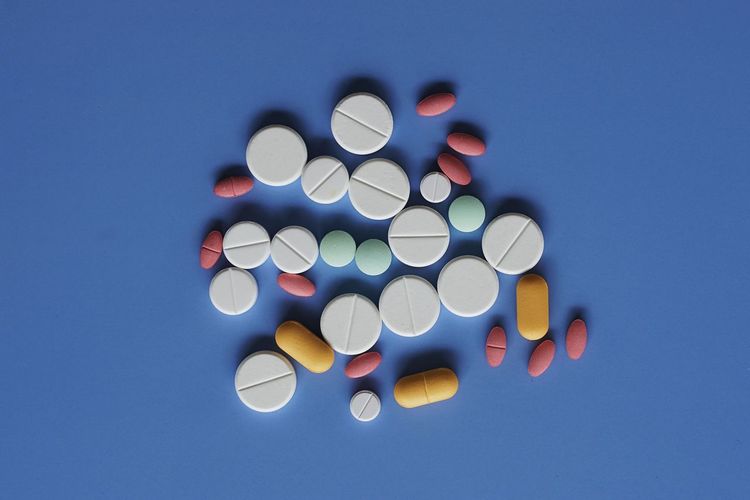 Multicolor pills on the blue background