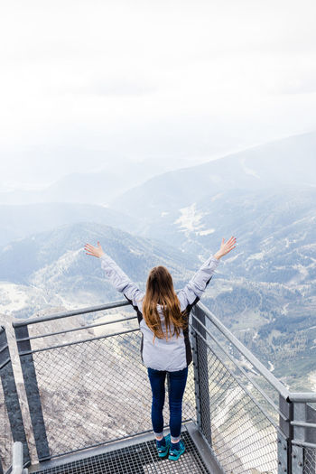 Young girl enjoys the views of the alps from the observation deck