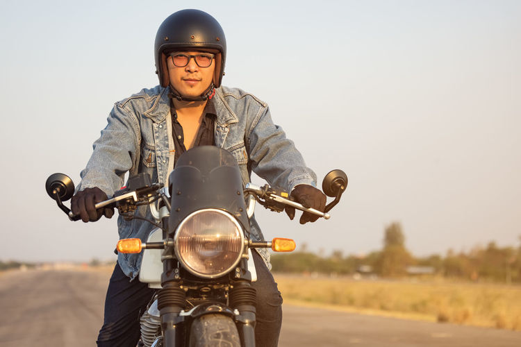 Young man riding big bike motocycle on asphalt high way against, motorbike man has freedom