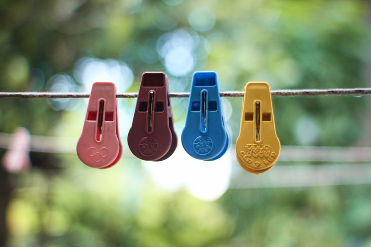 Close-up of shoes hanging on rope