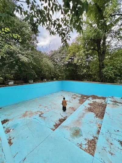 Rear view of shirtless man in swimming pool
