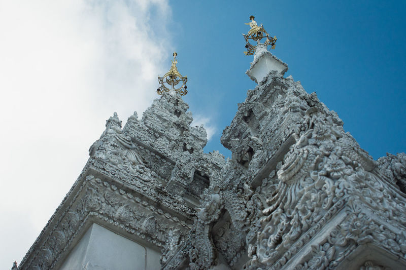 Low angle view of statue of temple against sky
