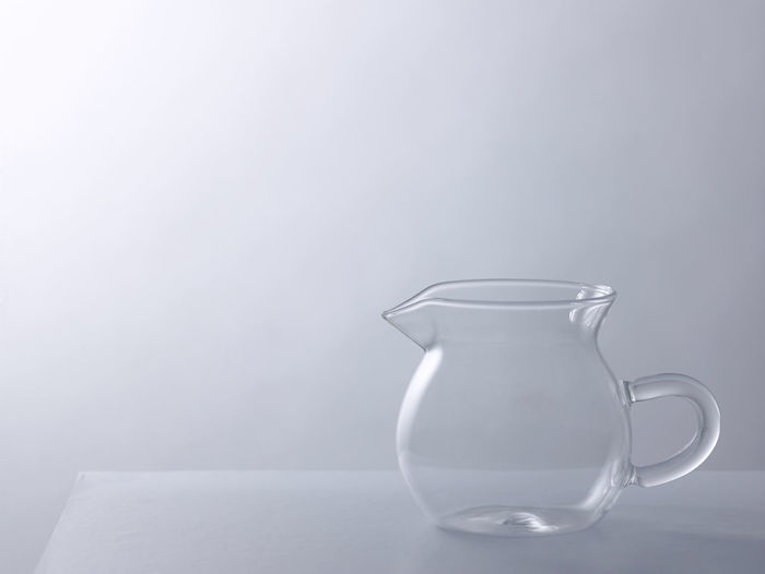 Empty glass jar on the gray background