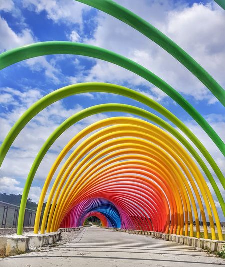 Multi colored bridge against sky