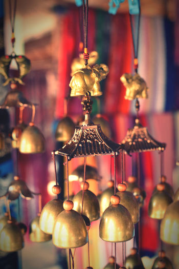 Close-up of illuminated pendant lights hanging from ceiling for sale