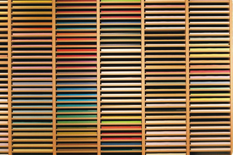 Full frame shot of multi colored papers on shelves
