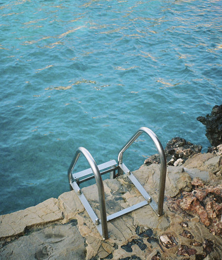 High angle view of ladder by the sea. shot on 35mm kodak portra 800