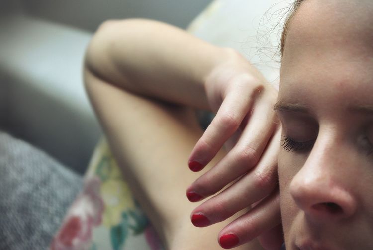 Cropped image of woman sleeping on bed
