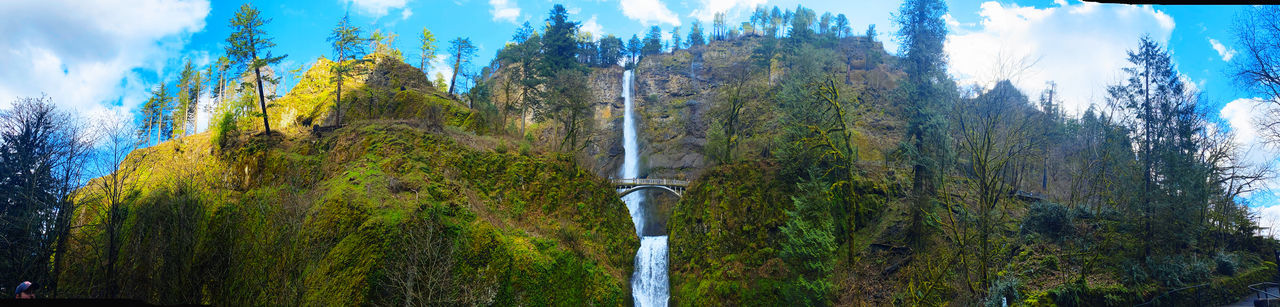 Panoramic view of waterfall against sky