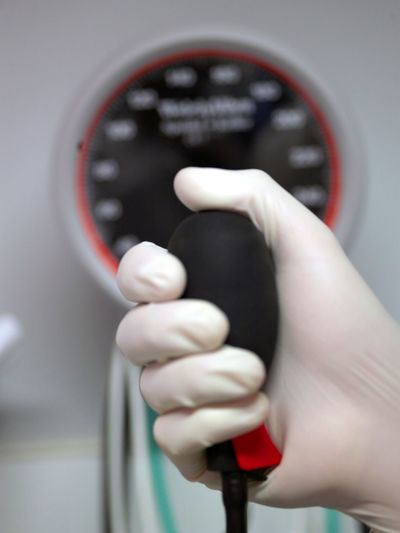 Cropped image of surgeon holding blood pressure gaugea