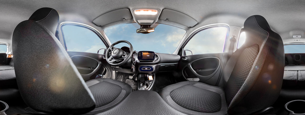 Electric car interior view as 360 degree panorama. the back seats are folded down. 